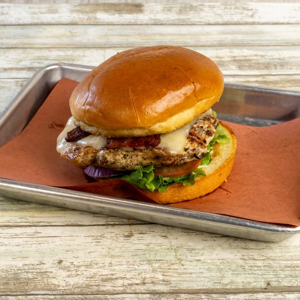 Gatlin's BBQ grilled chicken sandwich with melted cheese, bacon, lettuce, tomato, and onion.